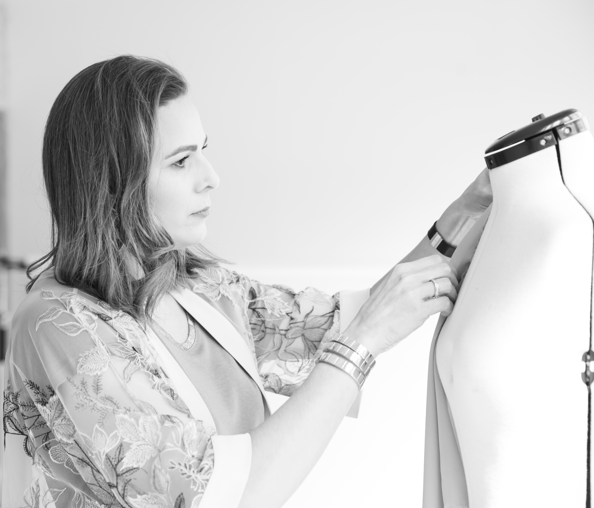 Mary Lee Gonçalves trabajando con un maniquí en su atelier, en blanco y negro